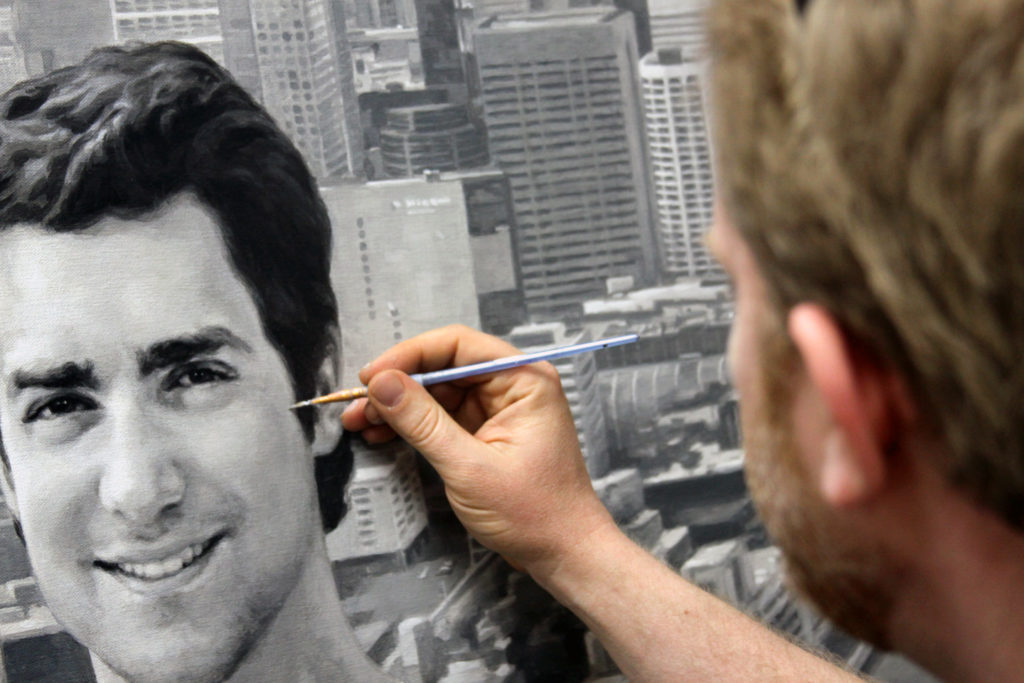 Artist Matt Philleo detailing a face within the 48" x 72" portrait.