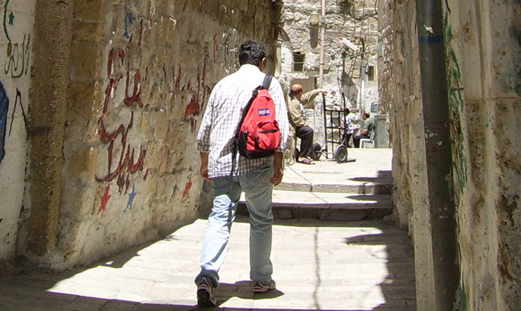 Middle Eastern man walking, public domain photo